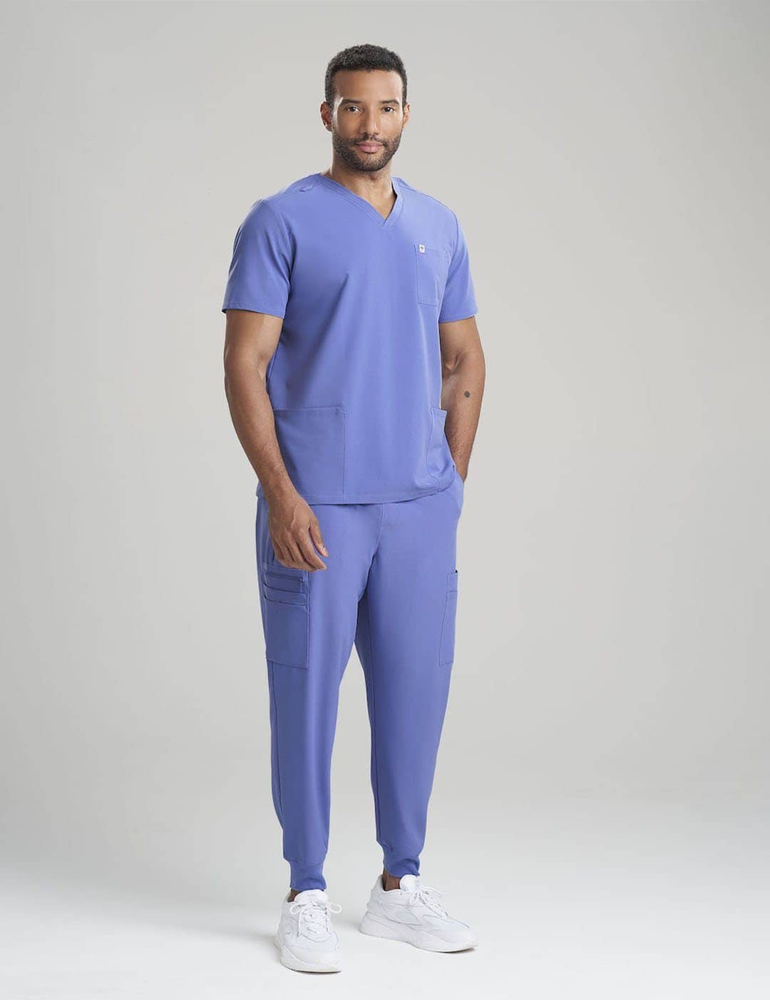 Professional men&#39;s scrub top in limited edition ceil blue, featuring a three-pocket layout and modern design