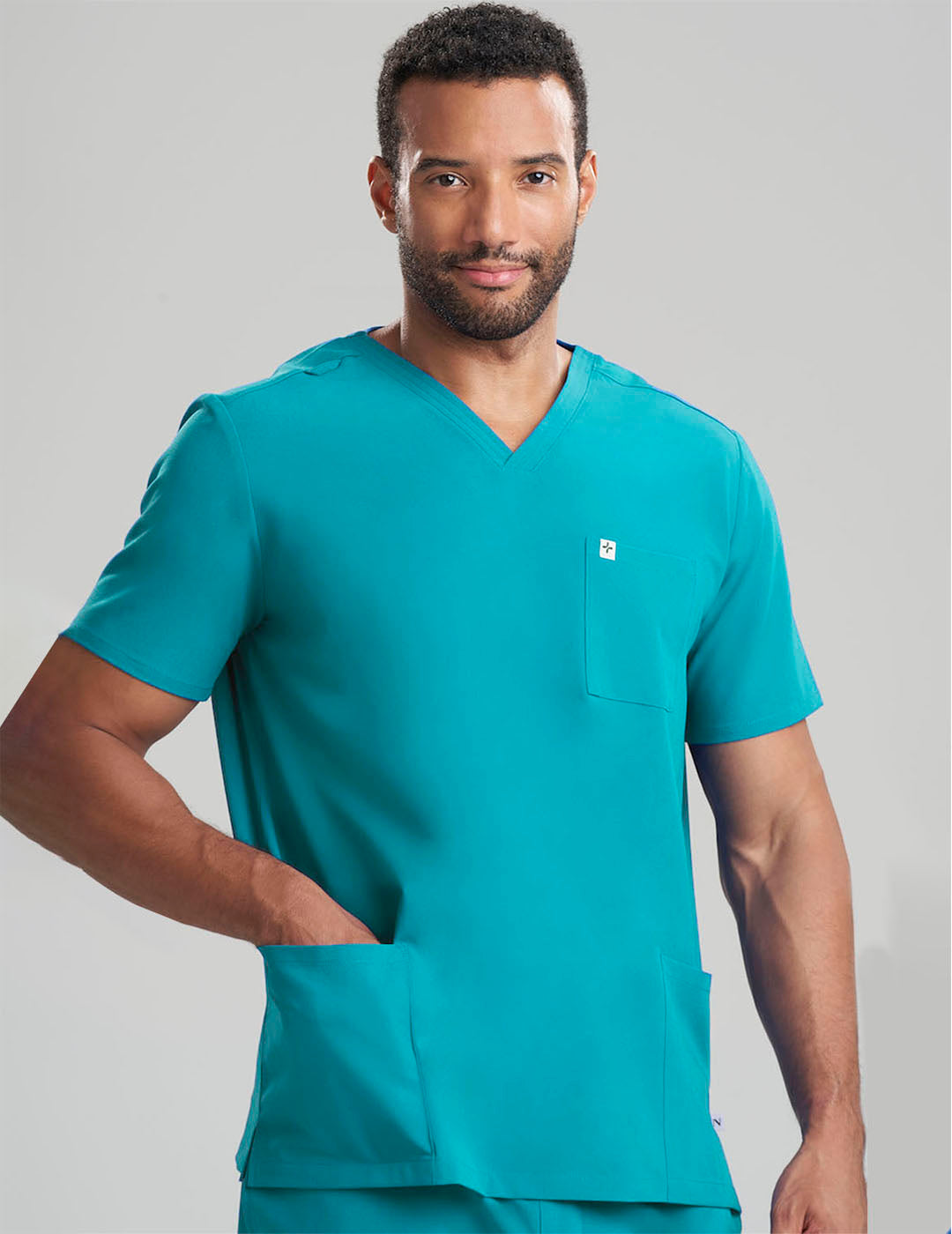 Durable and stylish men&#39;s scrub top in royal blue, crafted with three functional pockets in a limited edition style