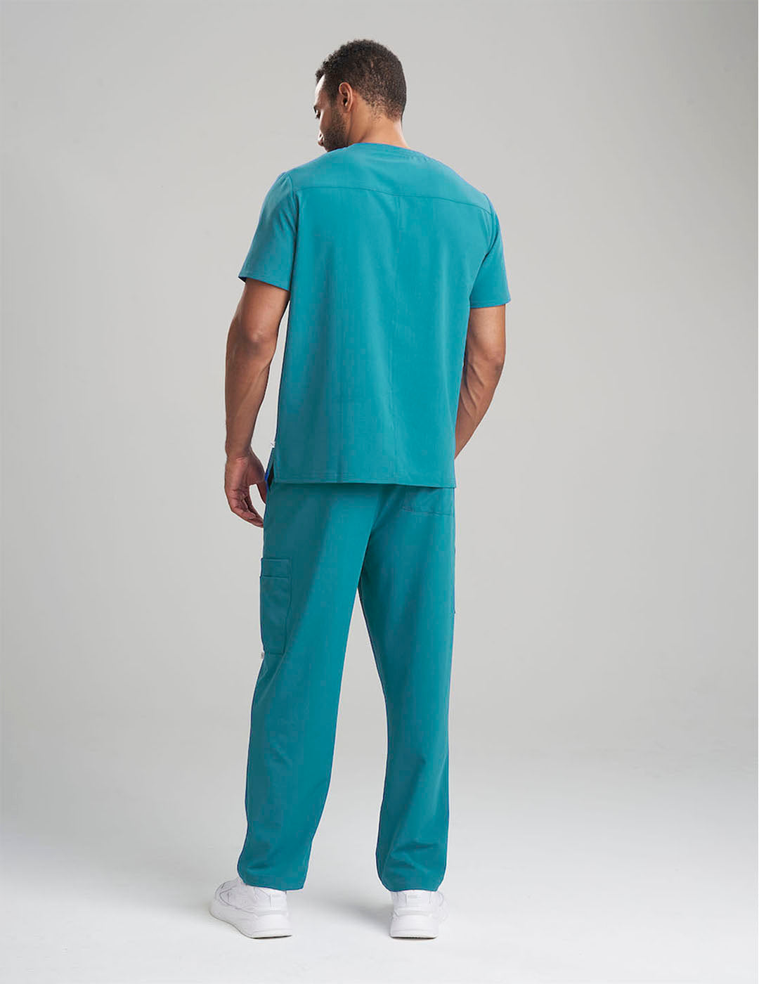 Sleek royal blue limited edition men&#39;s scrub top with three pockets, offering a modern and professional look